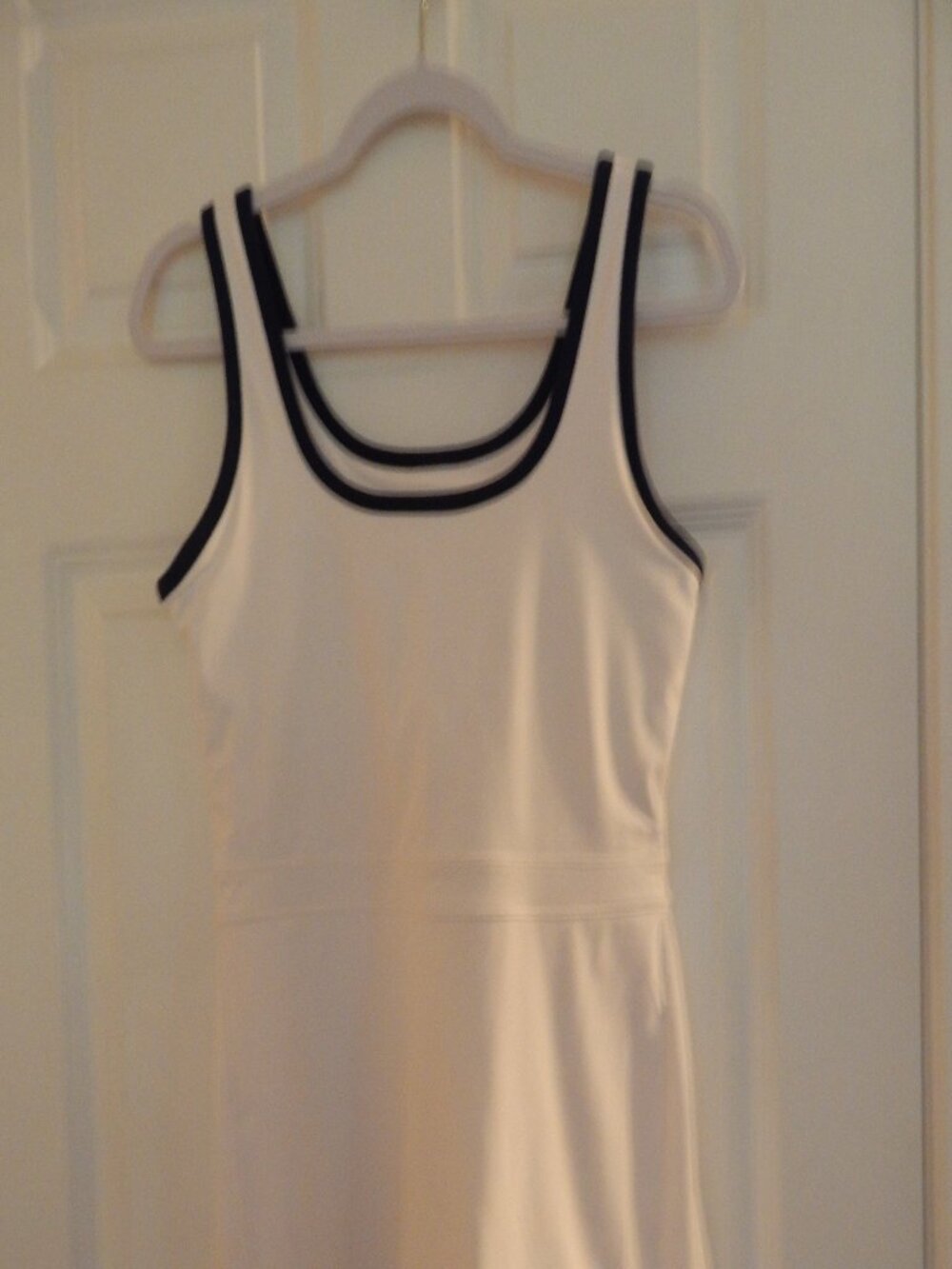 Fabletics tennis dress, white with blue trim, shorts with single pocket.